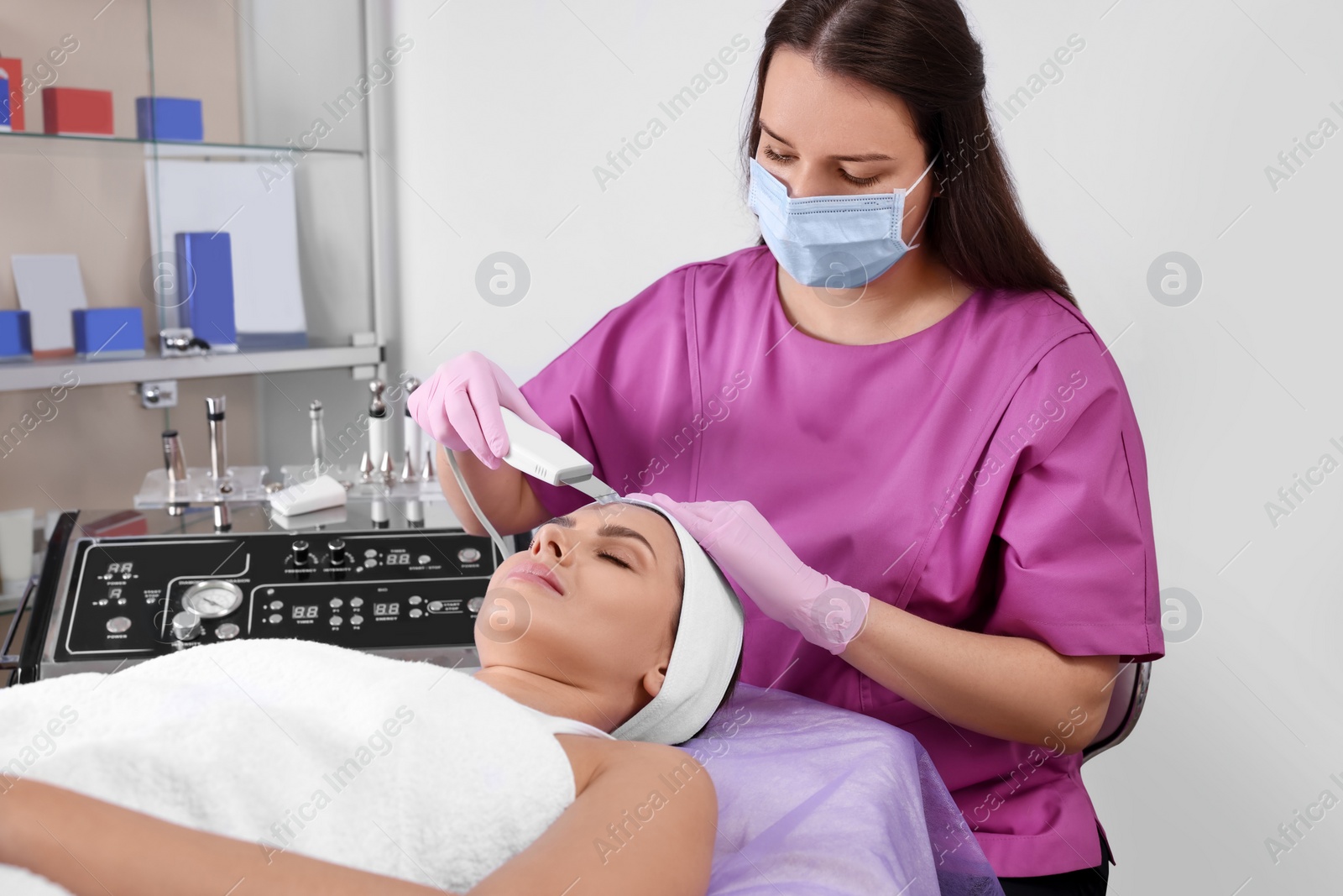 Photo of Young woman undergoing cosmetic procedure in beauty salon. Microcurrent therapy