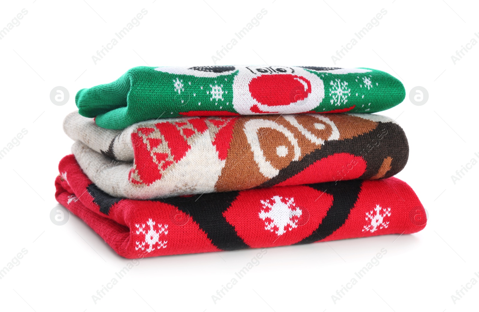 Photo of Stack of warm Christmas sweaters isolated on white