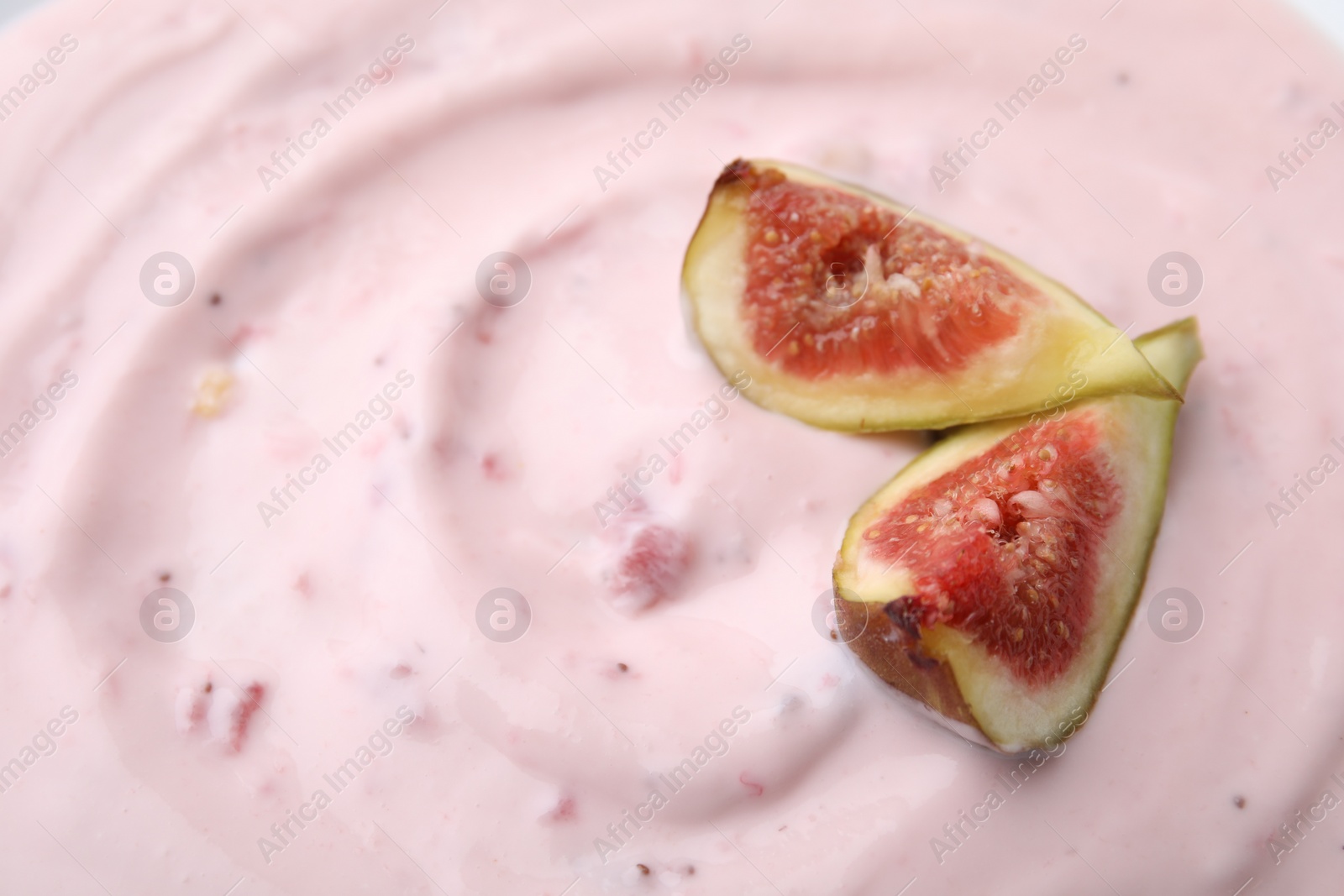 Photo of Tasty yogurt and figs as background, closeup. Space for text