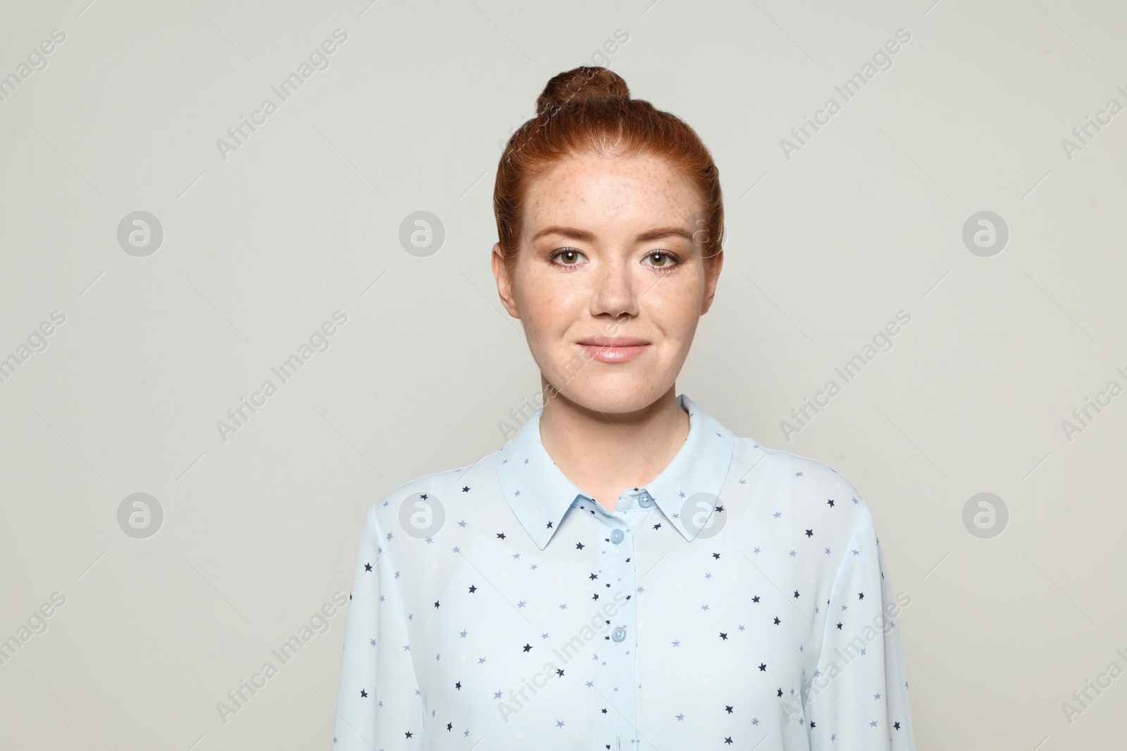 Photo of Portrait of young woman with beautiful face on grey background