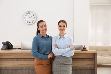 Photo of Portrait of beautiful receptionists near counter in hotel