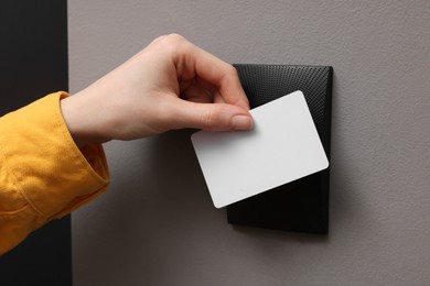 Photo of Woman opening magnetic door lock with key card, closeup. Home security