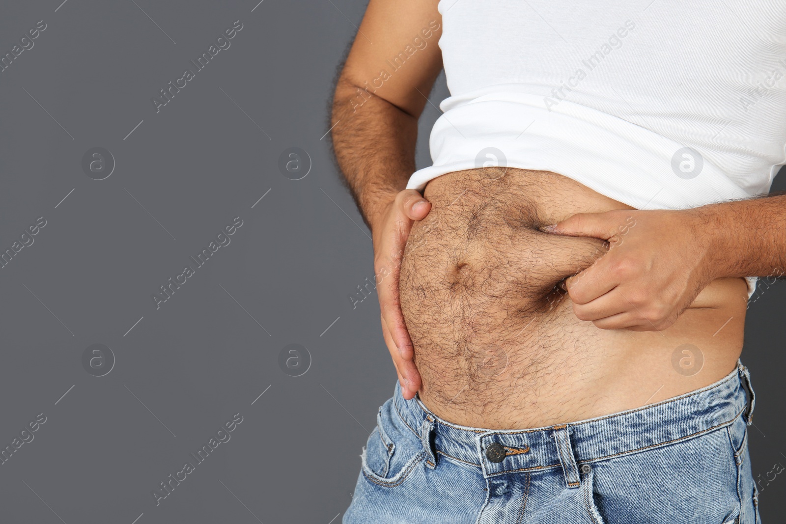 Photo of Overweight man on gray background, closeup view with space for text