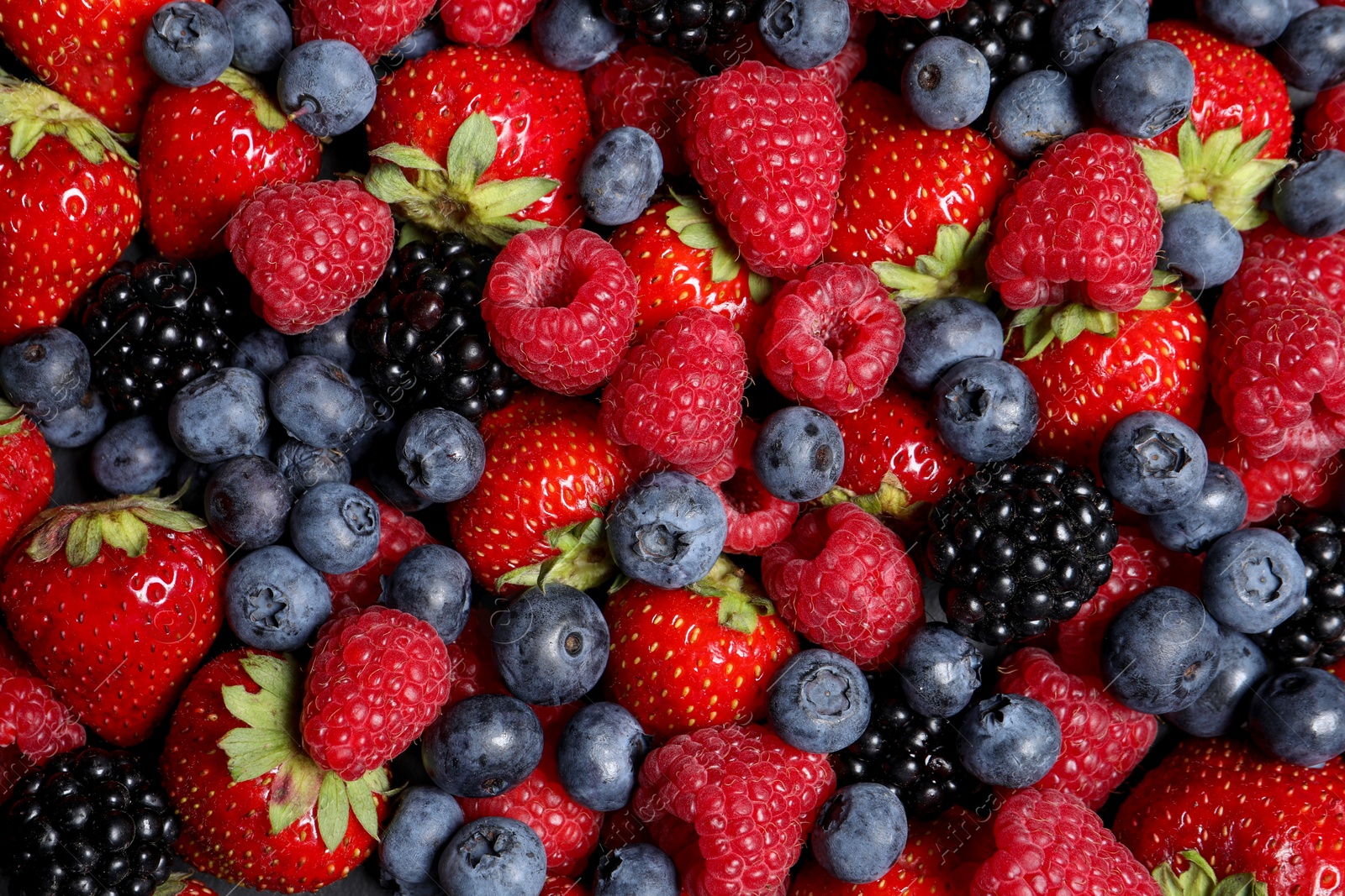 Photo of Assortment of fresh ripe berries as background, top view