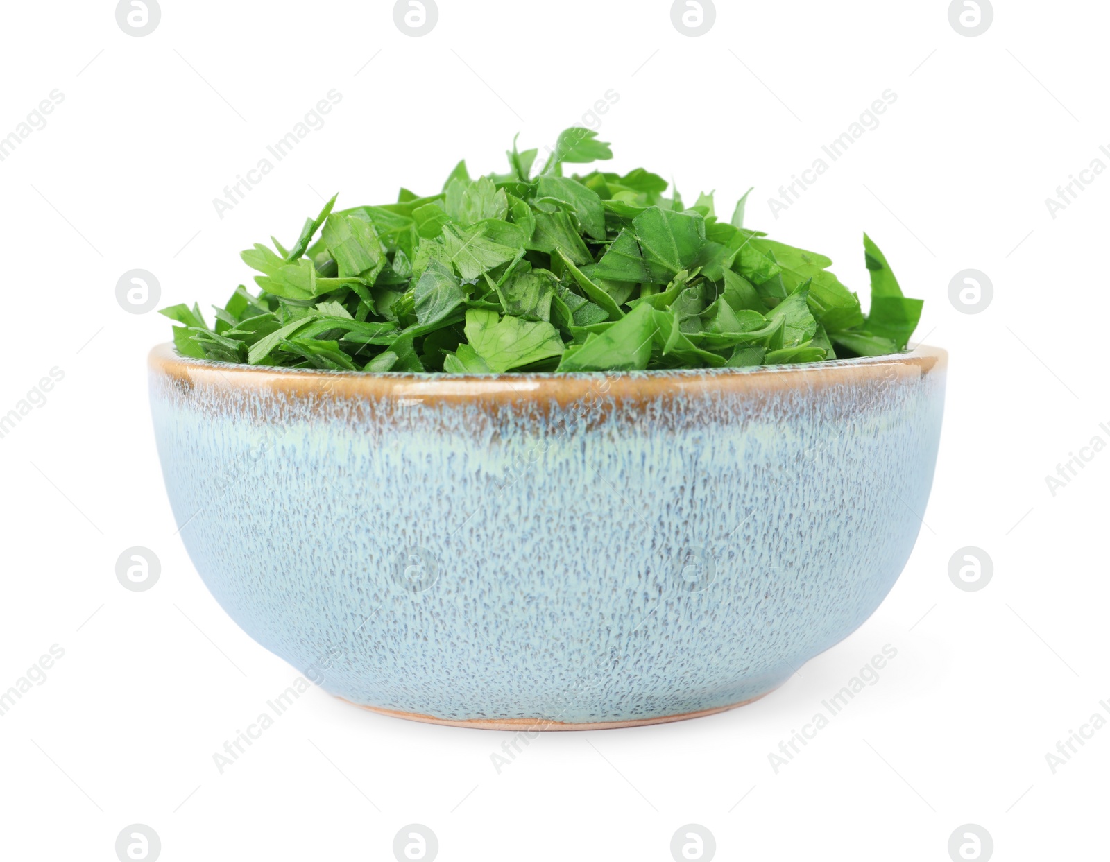 Chopped parsley leaves in bowl isolated on white Photo of Chopped parsley leaves in bowl isolated on white