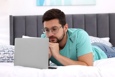 Man having video chat via laptop in bedroom