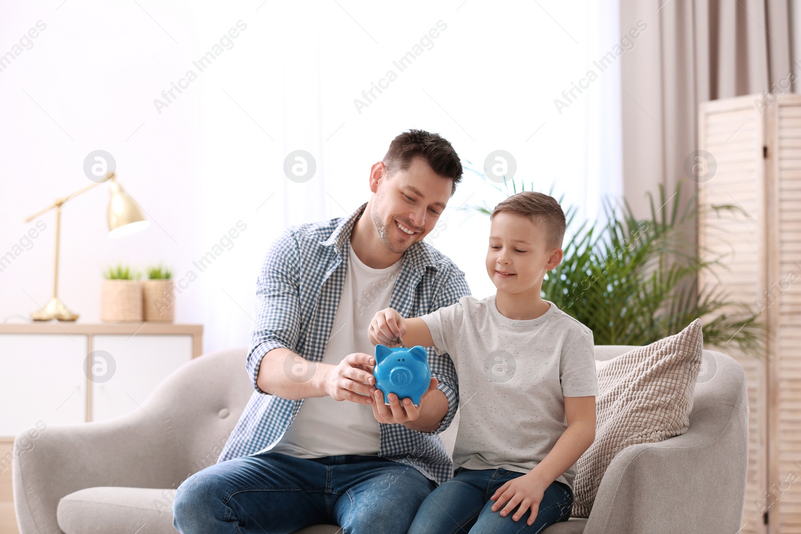 Photo of Family with piggy bank and money at home