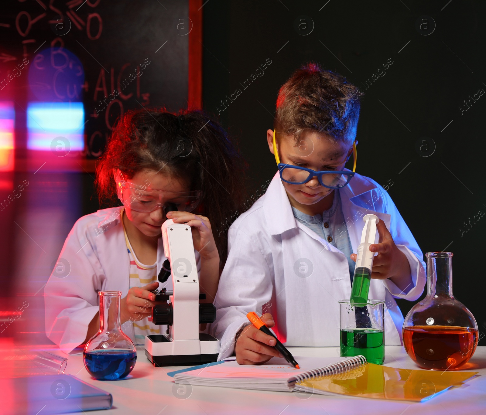 Photo of Children doing chemical research in laboratory. Dangerous experiment