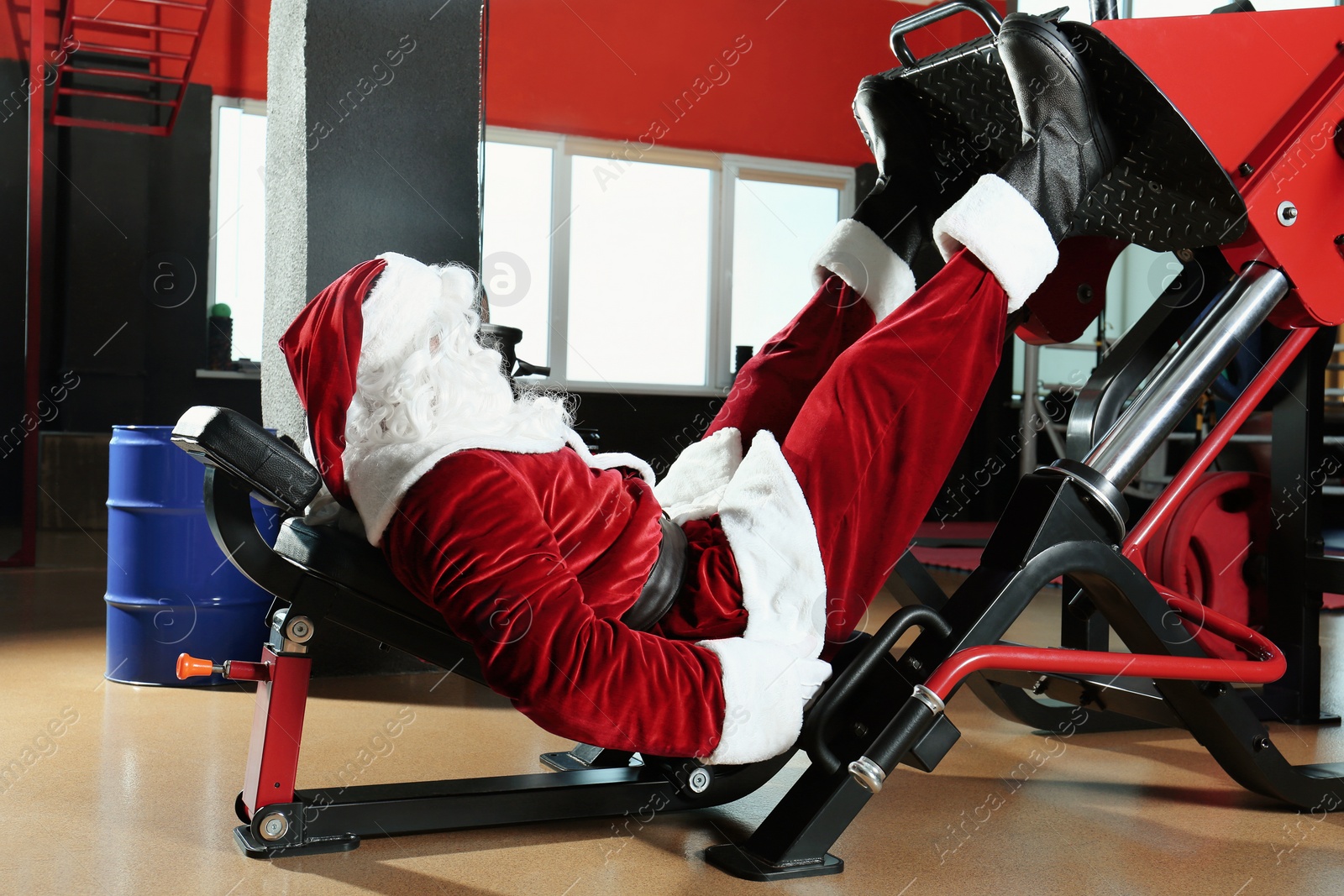 Photo of Authentic Santa Claus training in modern gym