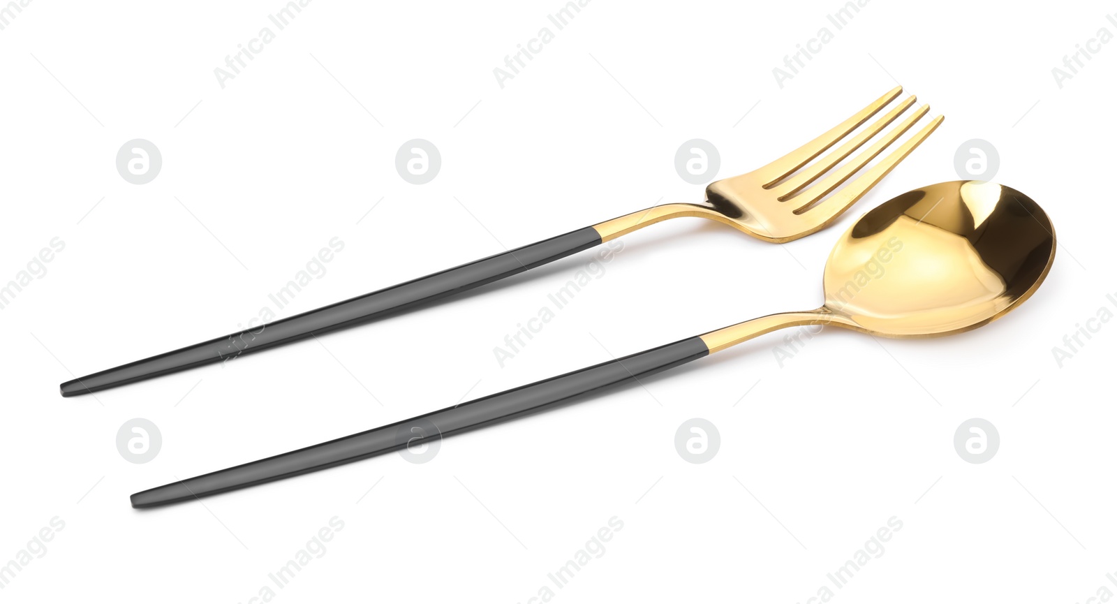 Photo of Shiny golden fork and spoon isolated on white. Luxury cutlery