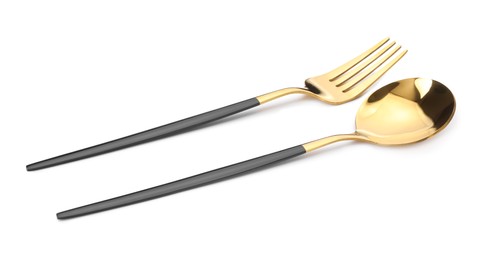 Photo of Shiny golden fork and spoon isolated on white. Luxury cutlery