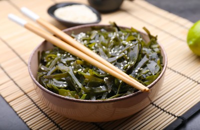 Photo of Fresh laminaria (kelp) seaweed served on black table