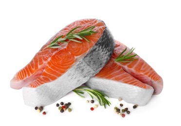 Photo of Fresh raw salmon steaks with rosemary and peppercorns on white background