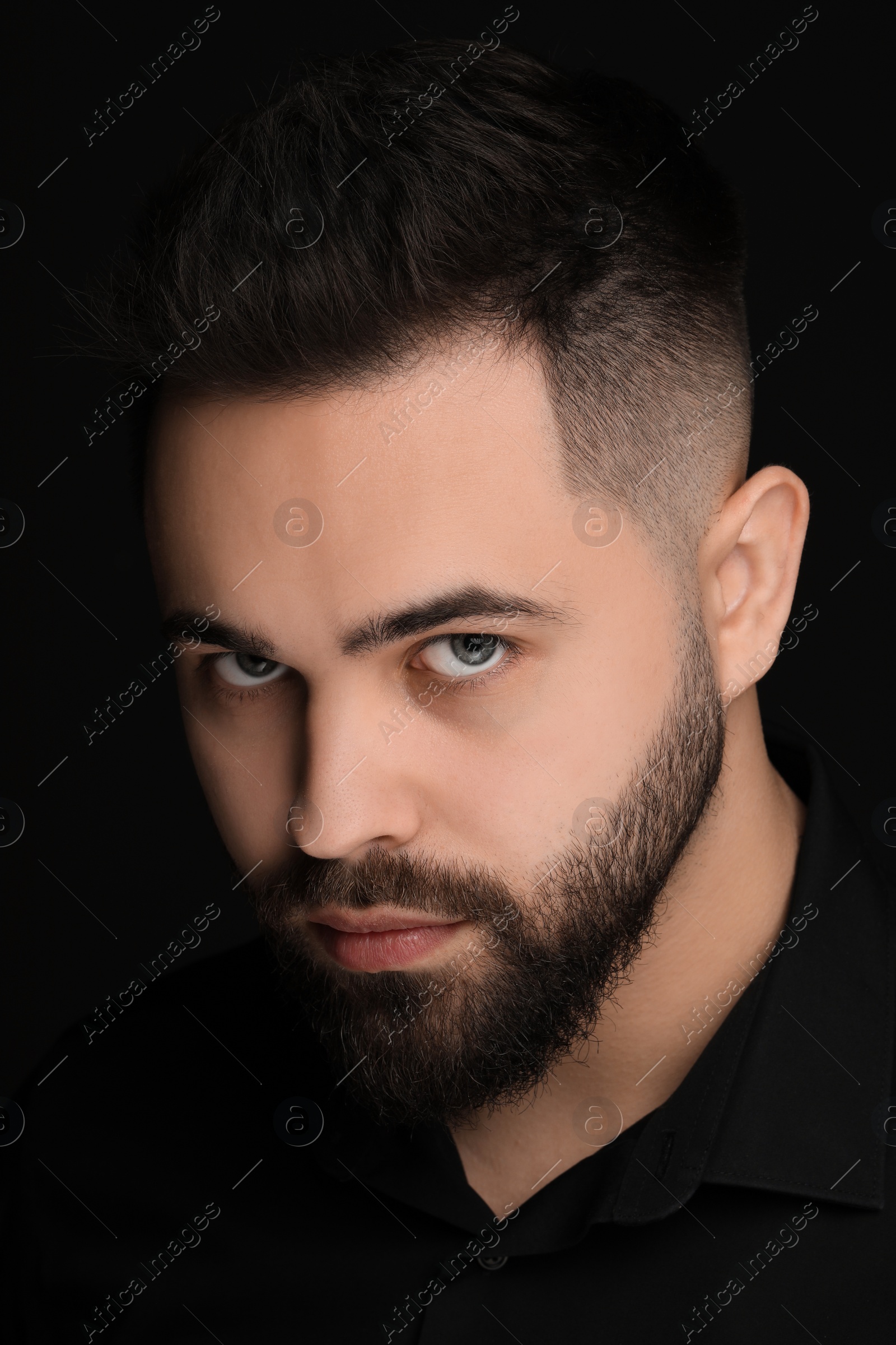 Photo of Evil eye. Man with scary eyes on black background