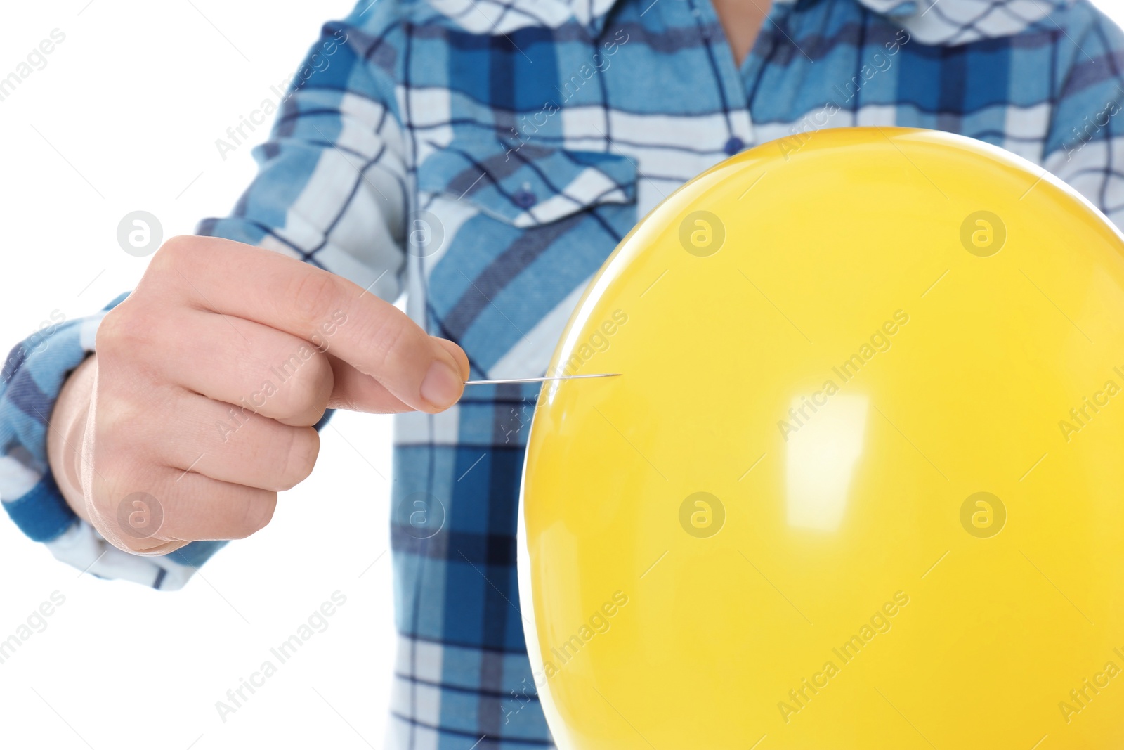 Photo of Woman piercing yellow balloon on white background, closeup