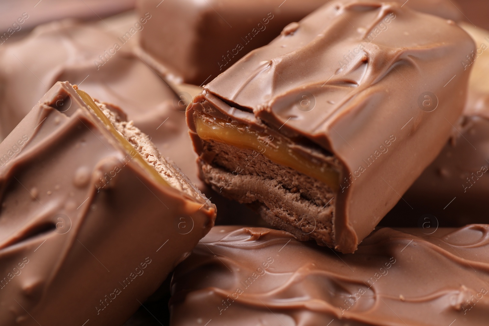 Photo of Tasty chocolate bars with nougat as background, closeup