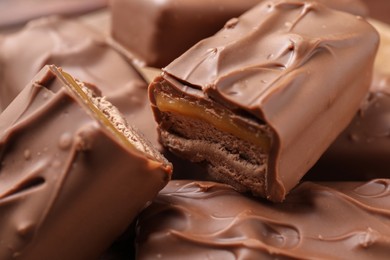 Tasty chocolate bars with nougat as background, closeup