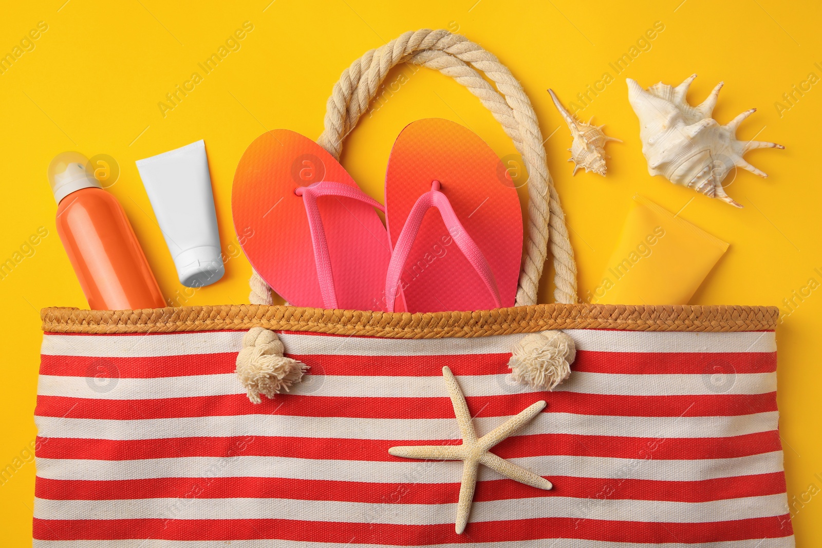 Photo of Flat lay composition with sunscreen on orange background. Sun protection