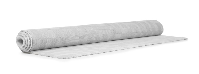 Photo of Rolled soft carpet on white background. Interior element