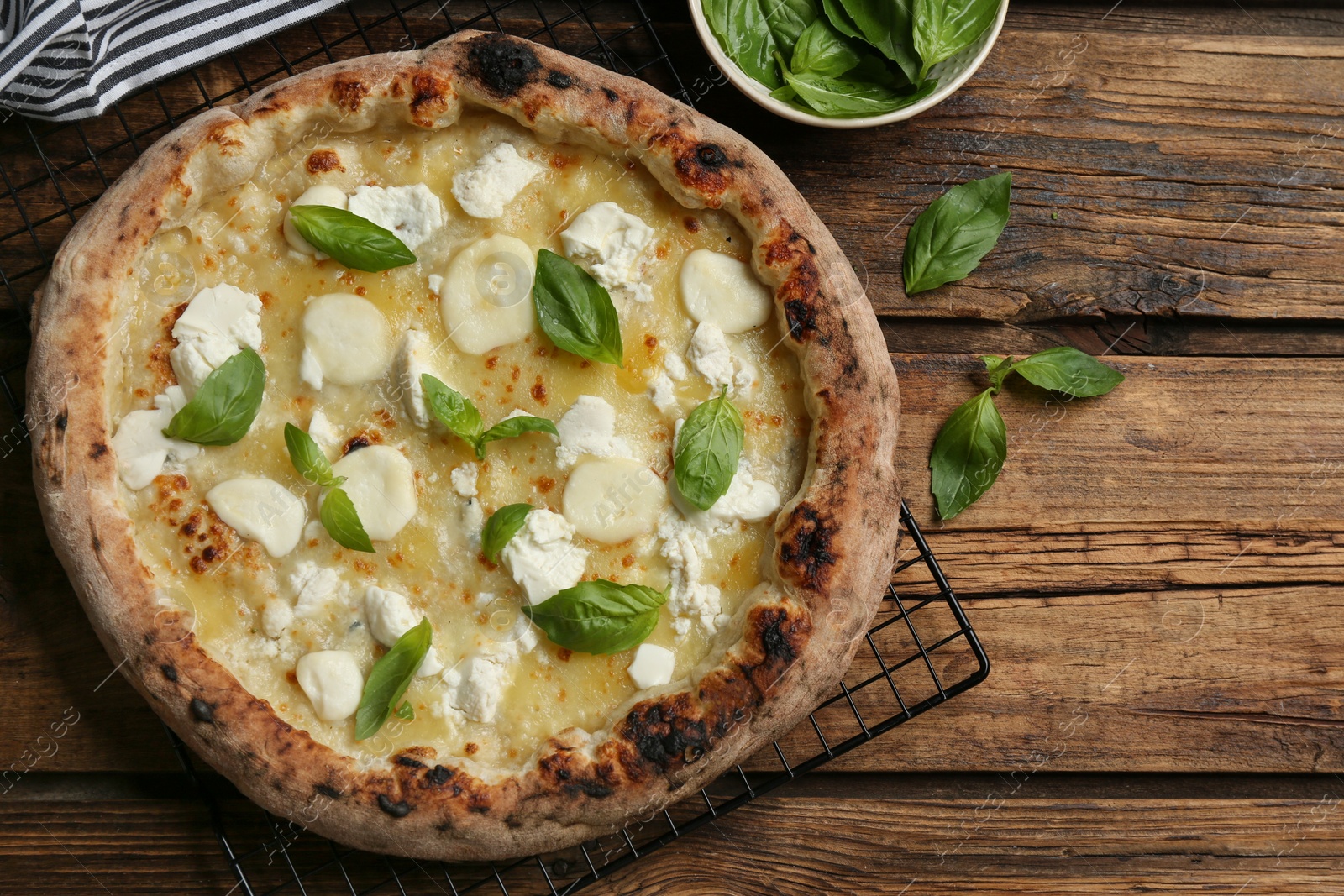 Photo of Tasty cheese pizza on wooden table, flat lay