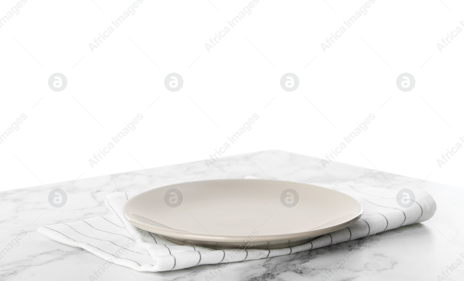 Photo of Empty grey plate and napkin on marble table against white background