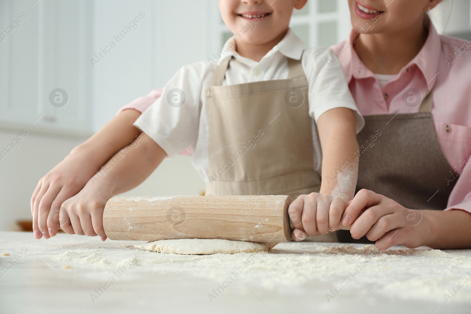 Photo of Mother and son cooking together at table, closeup