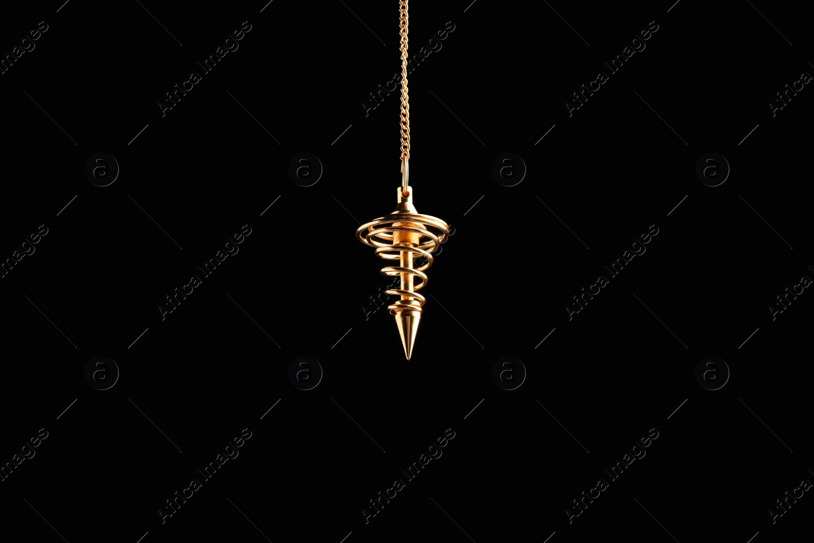 Photo of Beautiful golden pendulum with chain on black background. Hypnosis session