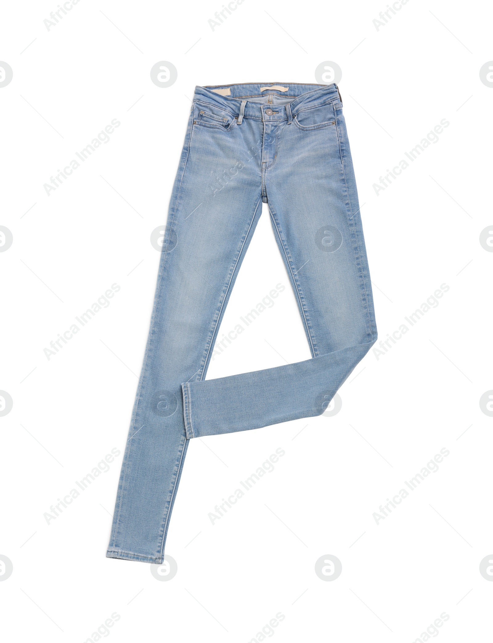 Photo of Stylish light blue jeans isolated on white, top view