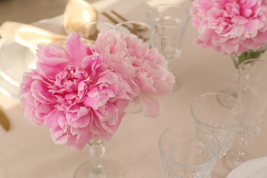 Stylish table setting with beautiful peonies. Space for text