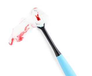 Brush and toothpaste foam with blood on white background, top view. Gum problems