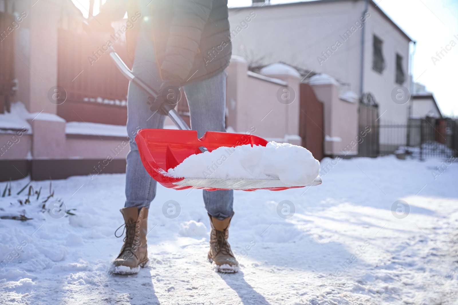 Photo of Person shoveling snow outdoors on winter day, closeup