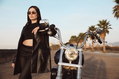 Photo of Beautiful young woman near motorcycle on sunny day