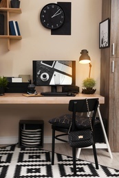 Stylish workplace interior with computer on table