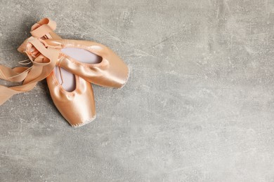 Photo of Ballet shoes. Elegant pointes on grey textured background, flat lay with space for text
