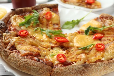 Photo of Delicious Hawaiian pizza with pineapple on table, closeup