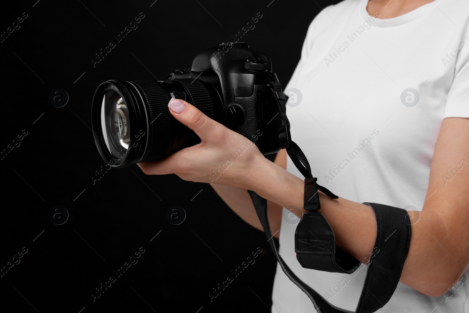 Photo of Photographer with camera on black background, closeup