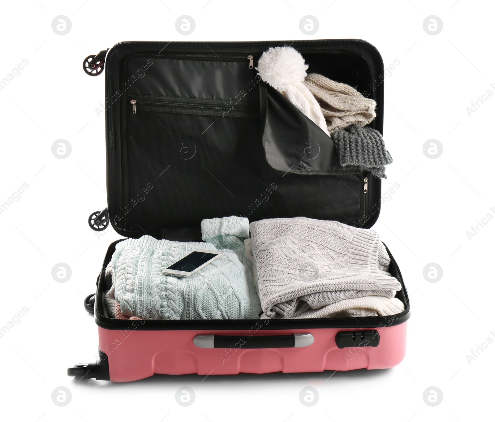 Photo of Packed suitcase with warm clothes and smartphone on white background. Space for text