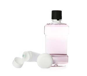 Photo of Mouthwash, dental floss and toothpaste on white background