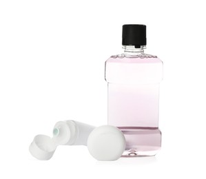 Mouthwash, dental floss and toothpaste on white background