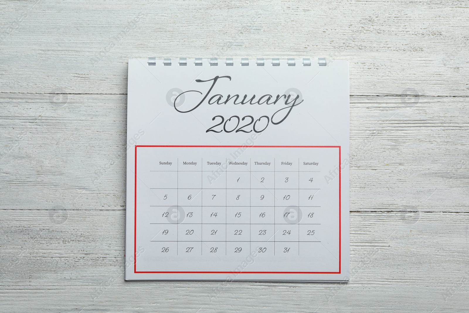 Photo of January 2020 calendar on white wooden background, top view