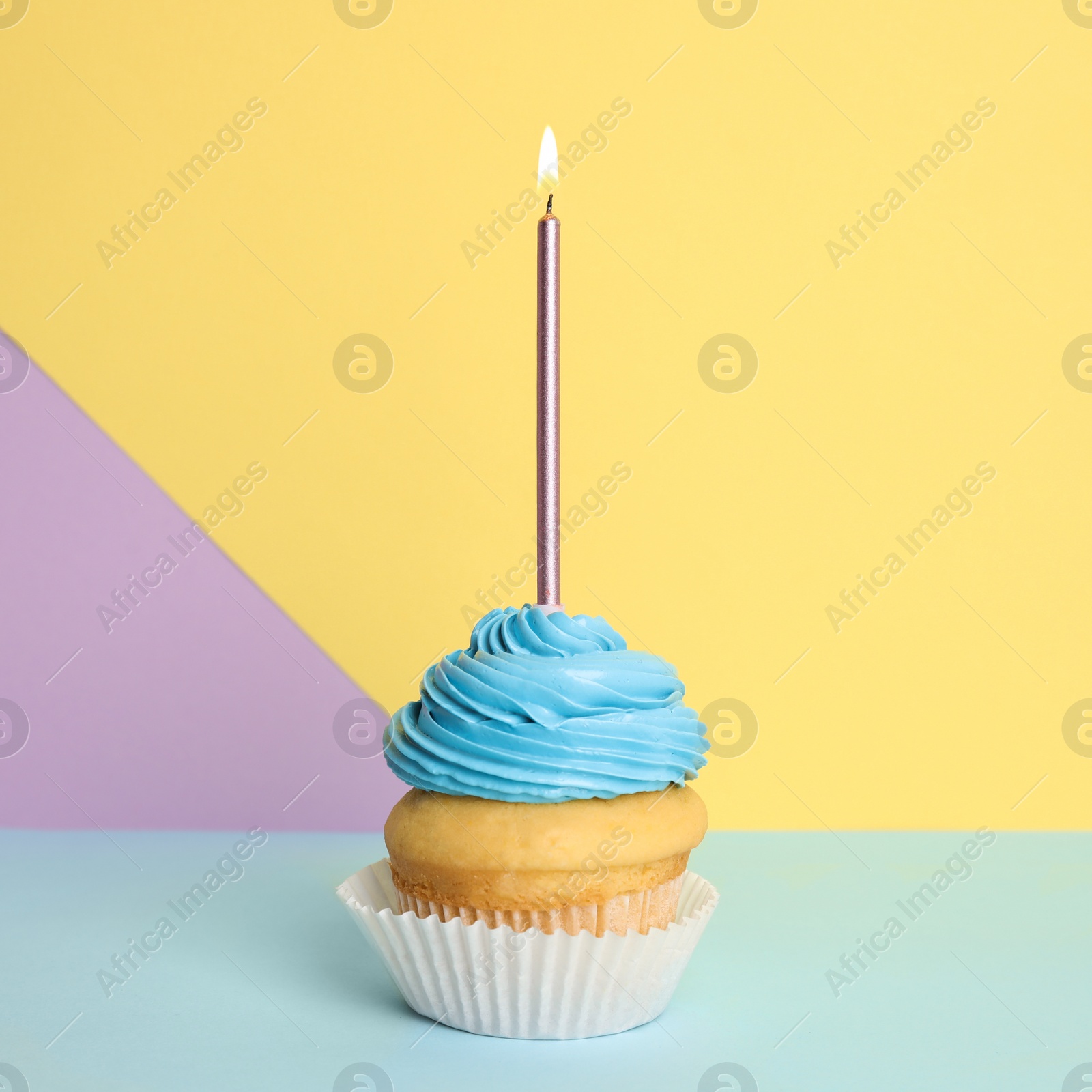 Photo of Birthday cupcake with candle on color background