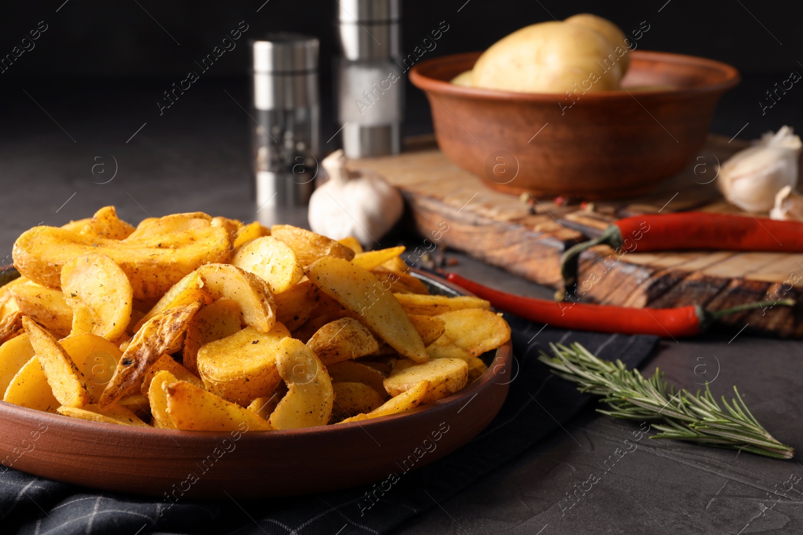 Photo of Plate of delicious oven baked potatoes on table, closeup. Space for text