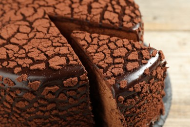 Photo of Delicious chocolate truffle cake on table, closeup