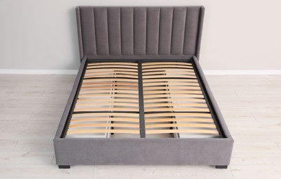 Photo of Comfortable bed with storage space for bedding under slatted base in room, above view