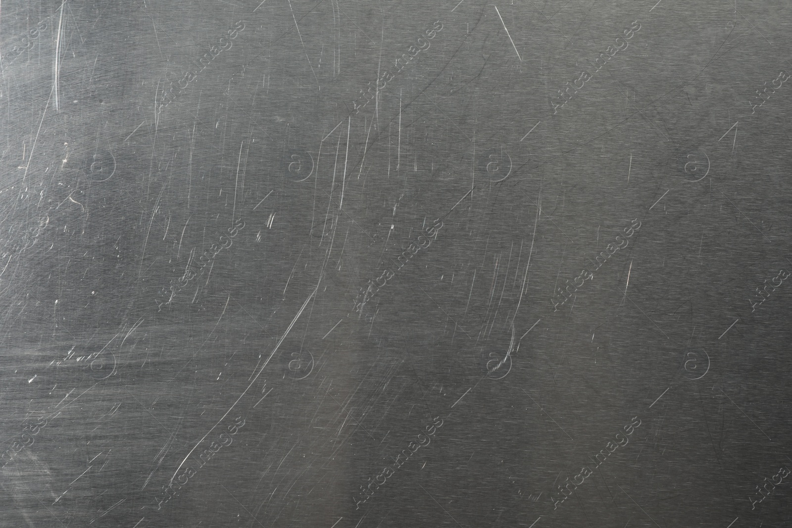 Photo of Old metal surface with scratches as background, closeup