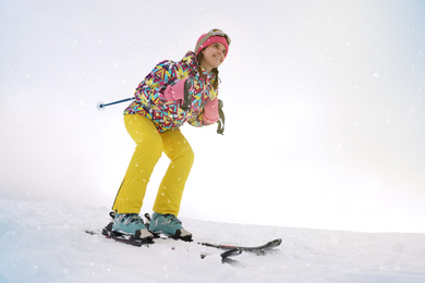 Young woman skiing on snowy hill. Winter vacation