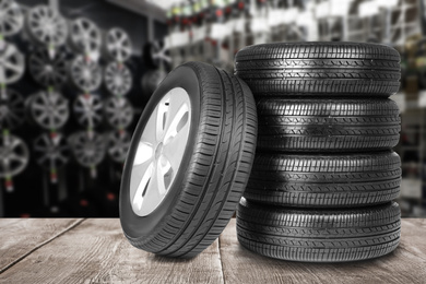 Image of Car tires on grey wooden surface in auto store