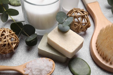 Photo of Beautiful composition with spa products and eucalyptus branches on light grey table