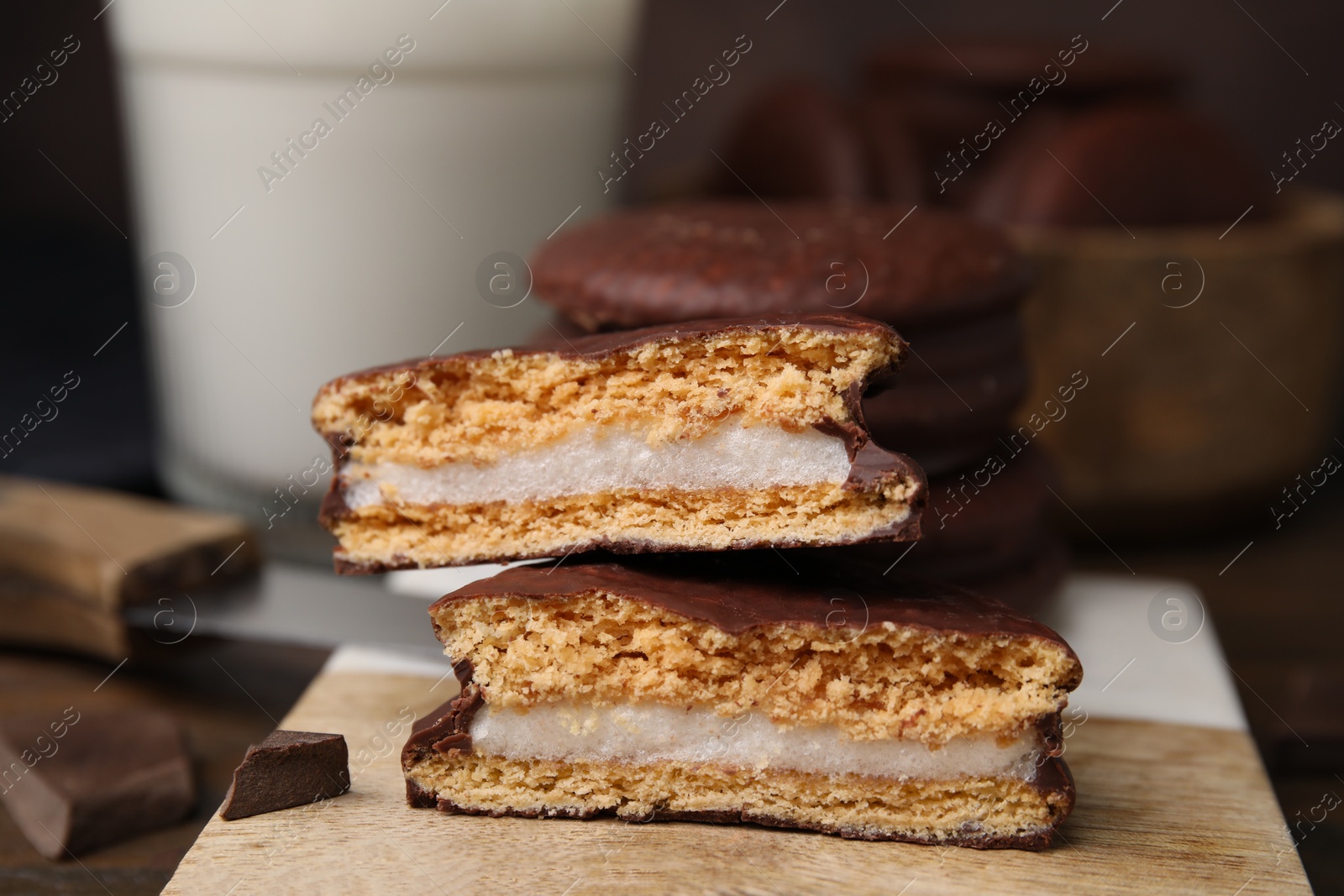 Photo of Tasty choco pies on coaster, closeup view