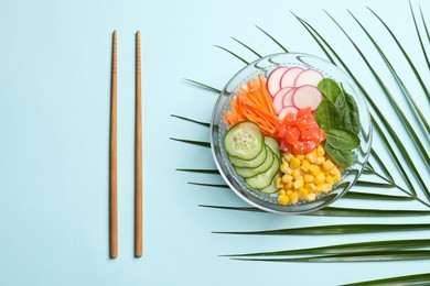 Photo of Delicious salad with salmon and vegetables on turquoise background, flat lay